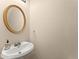 Pedestal sink and gold framed mirror in the half bathroom at 847 Edgeley Ln, Lawrenceville, GA 30044