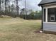 Expansive backyard with trees and a view of the surrounding landscape from the screened in porch at 89 Mayhaw Pt, Sharpsburg, GA 30277