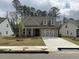 Charming home with a stone accent front, two-car garage, and well-maintained lawn at 89 Mayhaw Pt, Sharpsburg, GA 30277