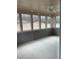 Enclosed sunroom with multiple windows offering backyard views and ample light at 89 Mayhaw Pt, Sharpsburg, GA 30277