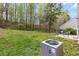 The back yard features a patio area and backs to a lush green space at 261 Silver Ridge Dr, Dallas, GA 30157