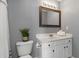 Bathroom featuring a wooden-framed mirror, white cabinets, and vanity at 261 Silver Ridge Dr, Dallas, GA 30157
