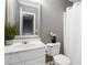 Bathroom with a sink, toilet, decorative plant and mirror at 261 Silver Ridge Dr, Dallas, GA 30157