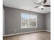 Bedroom with ceiling fan, hardwood floors, neutral-colored walls, and a large window at 261 Silver Ridge Dr, Dallas, GA 30157