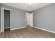 Bedroom featuring hardwood floors, neutral-colored walls, multiple closets, and modern ceiling fan at 261 Silver Ridge Dr, Dallas, GA 30157