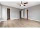 Bedroom with a ceiling fan, hardwood floors, neutral-colored walls, and multiple closets at 261 Silver Ridge Dr, Dallas, GA 30157