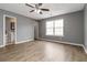 Bedroom features hardwood floors, a ceiling fan, a large window and an ensuite bathroom at 261 Silver Ridge Dr, Dallas, GA 30157