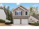 Charming two-story home featuring a stone-accented garage and well-manicured landscaping at 261 Silver Ridge Dr, Dallas, GA 30157
