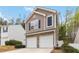 Two-story home featuring a stone facade and a two-car garage, complemented by manicured landscaping at 261 Silver Ridge Dr, Dallas, GA 30157