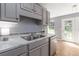 Galley kitchen features gray cabinets, marble-patterned countertops, and stainless steel appliances at 261 Silver Ridge Dr, Dallas, GA 30157