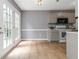 A spacious kitchen with gray cabinets, stainless steel appliances, and access to the backyard at 261 Silver Ridge Dr, Dallas, GA 30157