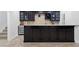 Basement wet bar featuring dark wood cabinets, granite countertop, and a wine fridge for entertaining at 325 Valley Brook Way, Atlanta, GA 30342