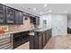 Spacious wet bar with dark cabinets, granite countertop, wine cooler, and ample storage space at 325 Valley Brook Way, Atlanta, GA 30342
