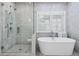 Bathroom featuring a soaking tub and glass-enclosed shower at 325 Valley Brook Way, Atlanta, GA 30342