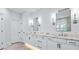 Elegant bathroom featuring a double vanity with marble countertops, modern fixtures, and decorative lighting at 325 Valley Brook Way, Atlanta, GA 30342