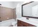 Traditional bathroom with tiled shower-tub combo and dark wood vanity topped with white sink at 325 Valley Brook Way, Atlanta, GA 30342