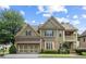 Inviting two-story home with a covered porch and manicured lawn, offering classic charm and curb appeal at 325 Valley Brook Way, Atlanta, GA 30342