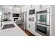 Bright white kitchen boasts stainless steel appliances and elegant countertops, connecting seamlessly to the living area at 325 Valley Brook Way, Atlanta, GA 30342