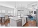 Open-concept kitchen features a large island with seating, stainless steel appliances, and hardwood floors at 325 Valley Brook Way, Atlanta, GA 30342