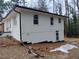 View of home showing basement access, white painted brick and siding and modern lines at 3543 S Cobb S Dr, Smyrna, GA 30080