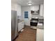 Modern kitchen featuring white cabinets, stainless steel appliances, and granite countertops at 3543 S Cobb S Dr, Smyrna, GA 30080