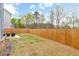 Spacious backyard with a wood privacy fence and patio area is perfect for entertaining at 4824 Sultana Sw Way, Atlanta, GA 30331
