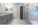 A bathroom with gray cabinets, granite countertop, and a glass enclosed marble shower at 4824 Sultana Sw Way, Atlanta, GA 30331
