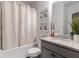 Well-lit bathroom features granite counters, shower-tub combo, and modern fixtures at 4824 Sultana Sw Way, Atlanta, GA 30331