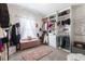 Walk-in closet with shelving, a pink rug, and a window at 4824 Sultana Sw Way, Atlanta, GA 30331