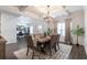 Open dining space with coffered ceilings, a modern chandelier, and an adjacent office provides a versatile layout at 4824 Sultana Sw Way, Atlanta, GA 30331