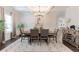 Bright dining area boasts stylish decor, a modern chandelier, and an adjacent kitchen with granite countertops at 4824 Sultana Sw Way, Atlanta, GA 30331