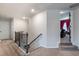 Upstairs hallway featuring neutral colors and carpeting and views to a media room at 4824 Sultana Sw Way, Atlanta, GA 30331