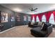 The large media room includes dark walls, carpeting, and comfortable seating at 4824 Sultana Sw Way, Atlanta, GA 30331