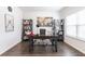 Bright home office featuring built-in bookshelves, a large desk, and natural light, ideal for remote work at 4824 Sultana Sw Way, Atlanta, GA 30331