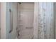 Tub/shower in a bathroom featuring a shower curtain, grab bar and tile surround at 537 Rendezvous Rd, Acworth, GA 30102