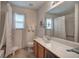 Bathroom featuring a single sink vanity, a large mirror and a tub shower at 537 Rendezvous Rd, Acworth, GA 30102