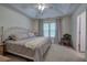 Cozy bedroom featuring a large window with curtains, neutral carpet and a ceiling fan at 537 Rendezvous Rd, Acworth, GA 30102