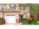 Charming townhome with a one-car garage and nicely landscaped front yard at 537 Rendezvous Rd, Acworth, GA 30102