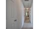 Hallway featuring neutral-toned walls, carpeted floor, and a series of white doors creating a clean and bright path at 537 Rendezvous Rd, Acworth, GA 30102