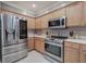Stainless steel appliances are the focal point in this spacious kitchen with light colored cabinetry at 537 Rendezvous Rd, Acworth, GA 30102