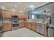 Well-equipped kitchen featuring stainless steel appliances, ample counter space, and natural wood cabinets at 537 Rendezvous Rd, Acworth, GA 30102