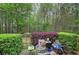 Outdoor patio with green landscape, seating, and blooming flowers at 537 Rendezvous Rd, Acworth, GA 30102