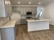Well-equipped kitchen features gray cabinets, an island with bar seating, and stainless steel appliances at 76 Mayhaw Pt, Sharpsburg, GA 30277