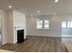 Bright living room with wood floors, fireplace, recessed lights, and sliding glass doors to the porch at 76 Mayhaw Pt, Sharpsburg, GA 30277