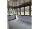 Enclosed sunroom with ceiling fan and large windows overlooking the backyard at 76 Mayhaw Pt, Sharpsburg, GA 30277