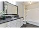Well-maintained bathroom with a sleek vanity, decorative mirror, and shower-tub combination at 8450 Sundial Ct, Johns Creek, GA 30024