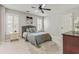Well-lit bedroom featuring a comfortable bed, ample natural light, and a neutral color scheme at 8450 Sundial Ct, Johns Creek, GA 30024