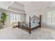 Spacious bedroom with tray ceiling, sitting area and shuttered windows at 8450 Sundial Ct, Johns Creek, GA 30024
