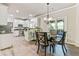 Bright dining area with stylish lighting fixture adjacent to kitchen at 8450 Sundial Ct, Johns Creek, GA 30024