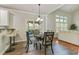 Well-lit dining area featuring stylish chairs and access to outdoor seating at 8450 Sundial Ct, Johns Creek, GA 30024
